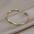 Gold twisted alloy bracelet with geometric Korean style design and 6.2cm inner ring diameter