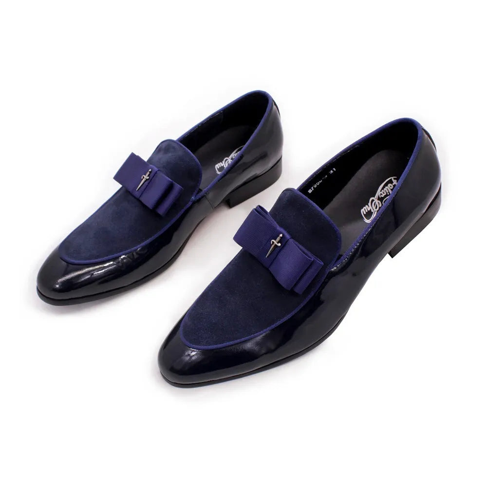 Men's black patent leather tassel loafers with a matte toe, shown on a wooden floor.