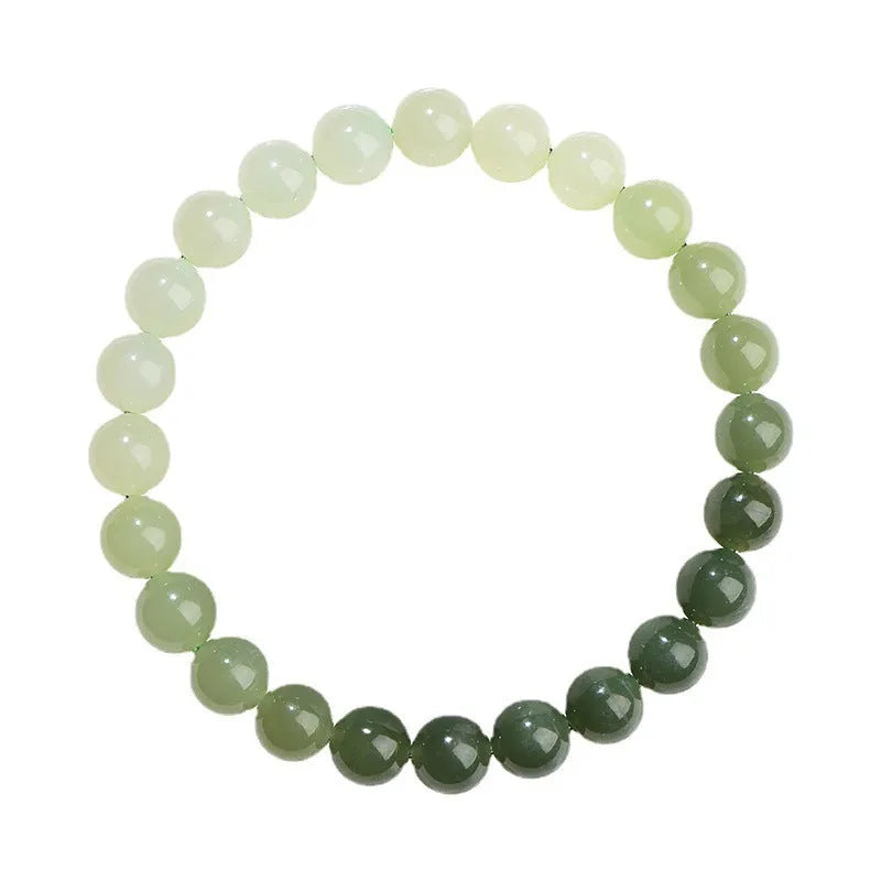 Natural Hetian jade bracelet with gradient clear water colour beads on a wrist.