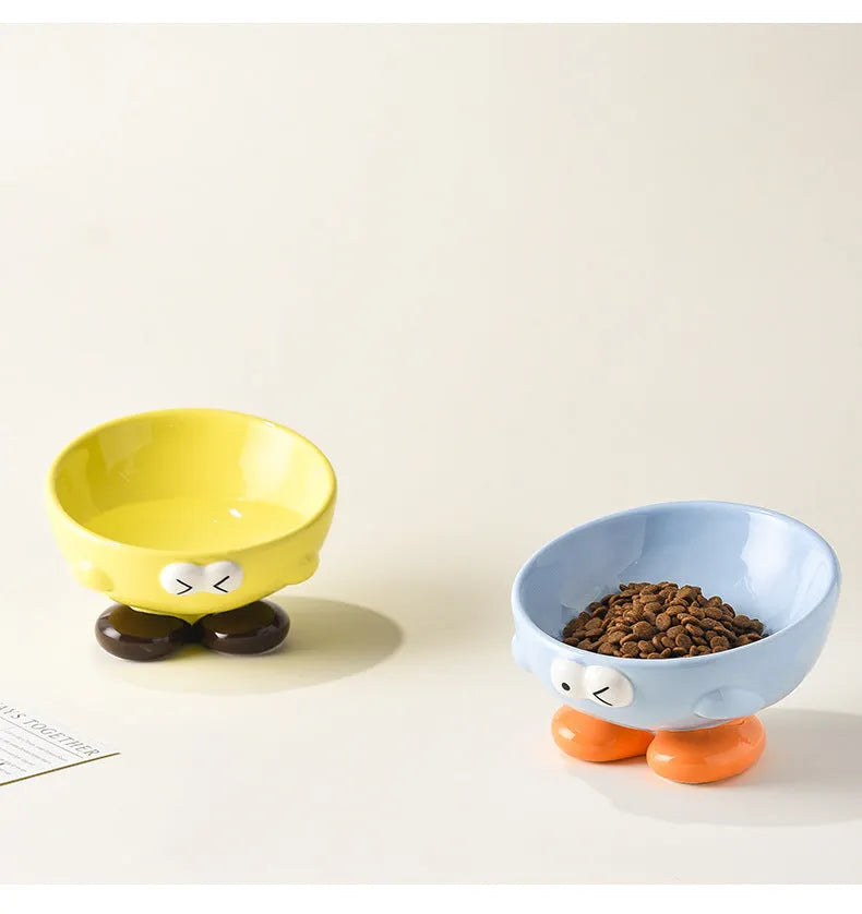 Ceramic pet bowl with oblique design and cute expressions for cervical spine protection