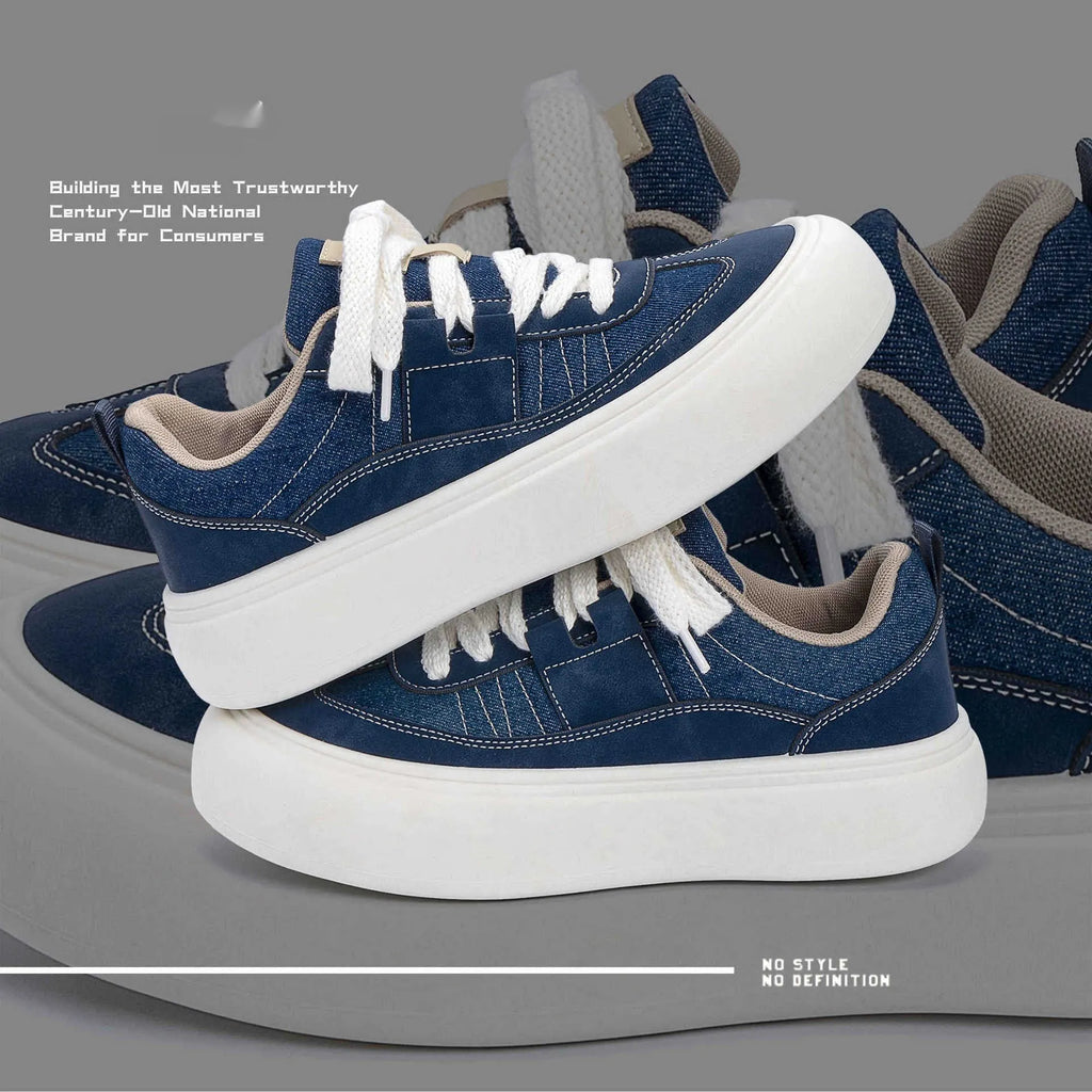Men's black canvas platform sneakers with round toe and lace-up front on grey background