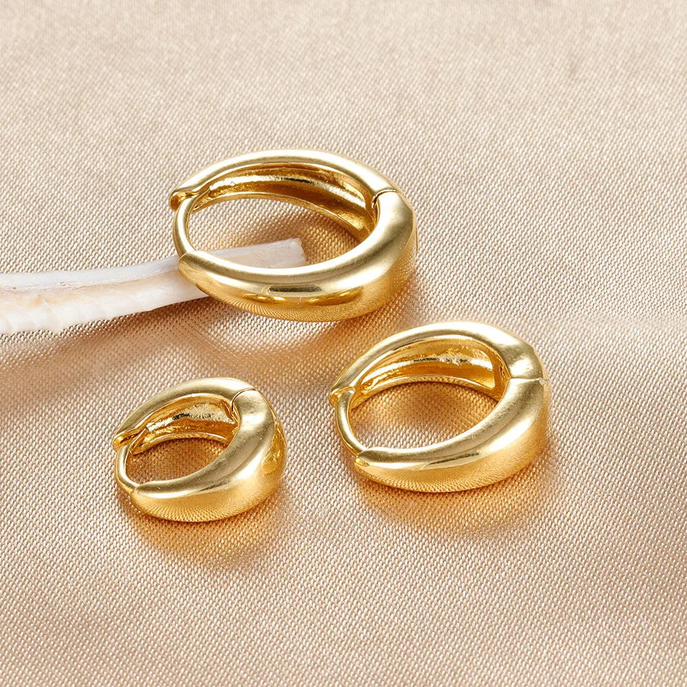 Geometric copper earring set of 3 glossy gold electroplated round shape earrings on display