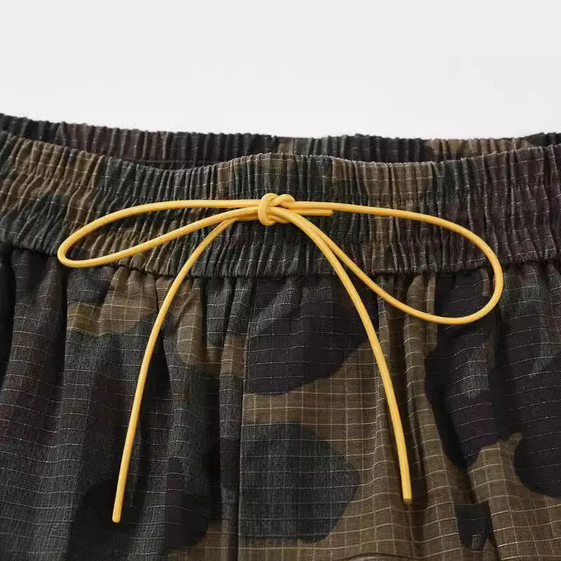 Green washed camouflage cotton cargo shorts with multiple pockets on a mannequin