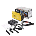 Household MMA-200MIN 220V DC inverter welding machine with cables, tongs, clamp, and face shield on a workbench.