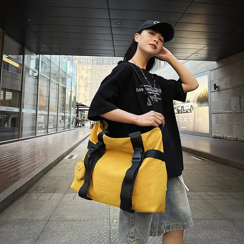 Men's grey Oxford cloth travel shoulder bag showing large main compartment and separate coin purse.