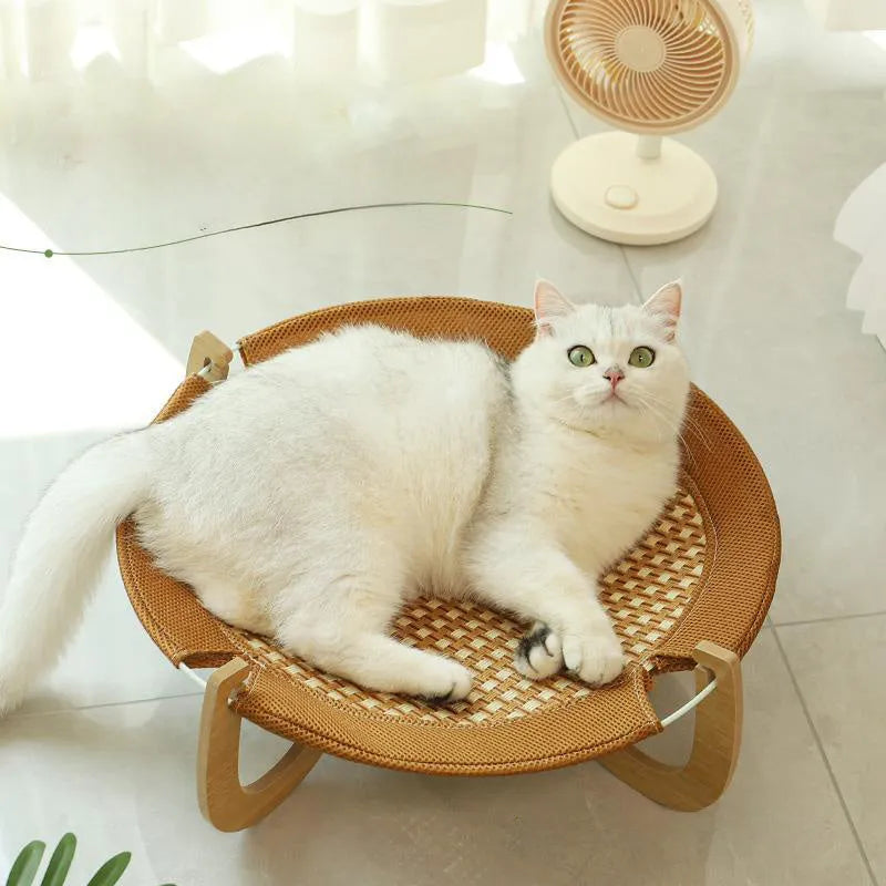 Brown woven rattan square pet hammock bed elevated off the ground.