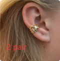 Gold-coloured starfish and scallop shell women's alloy earrings on a white background.
