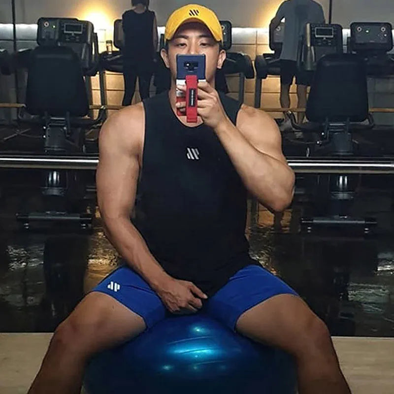 A pair of loose-fitting metal silk sports shorts in sapphire blue, laid flat to show the simple design and no-liner construction.