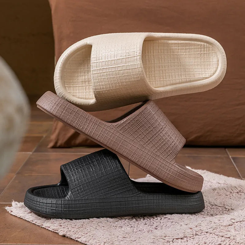 Pair of EVA toe ring flip flop slippers on a wet floor, showing non-slip sole pattern.