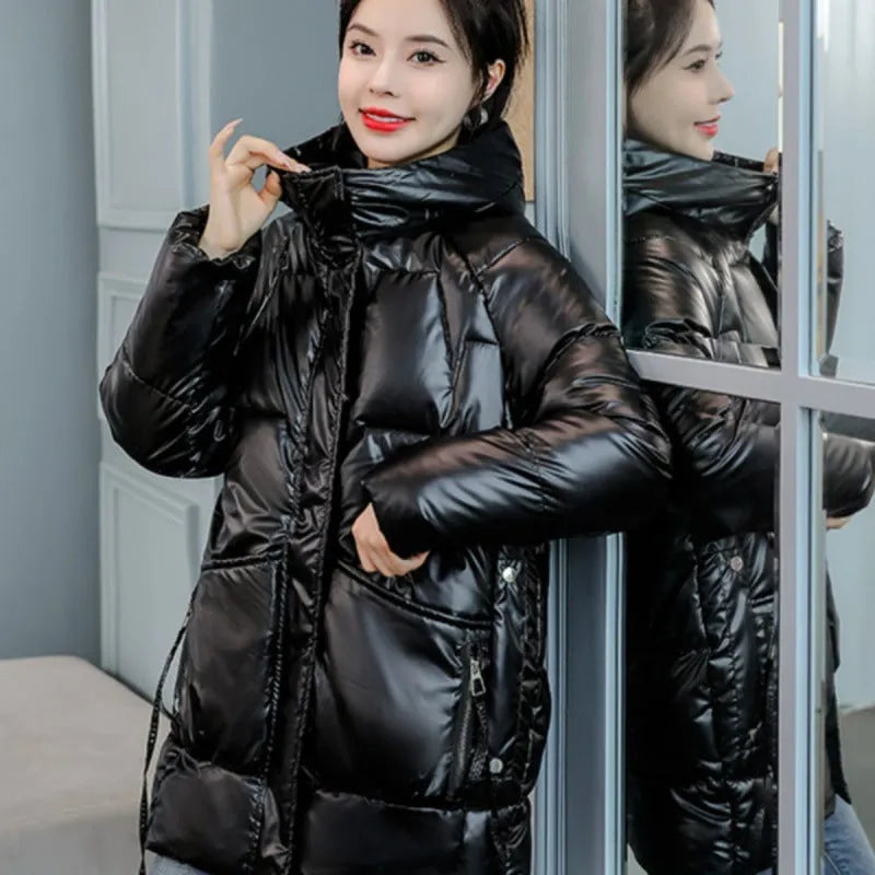 A woman's loose-fit hooded winter jacket in a poly-cotton blend, shown in a choice of colours including black and champagne.
