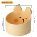 White and yellow ceramic pet bowls with rabbit and bear motifs in two sizes