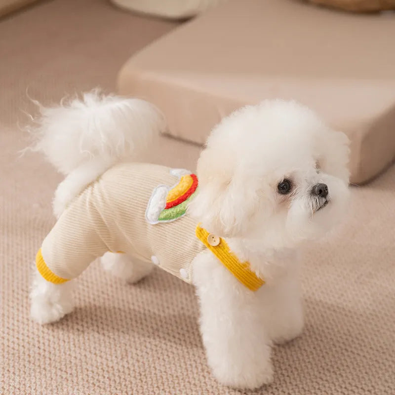Small dog wearing beige corduroy overalls with rainbow print, autumn winter outfit