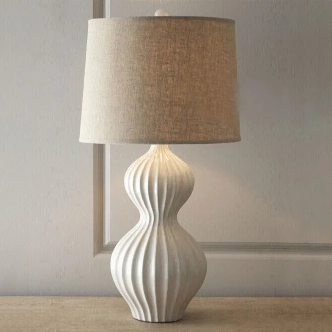 Ceramic base table lamp with fabric shade in country style.