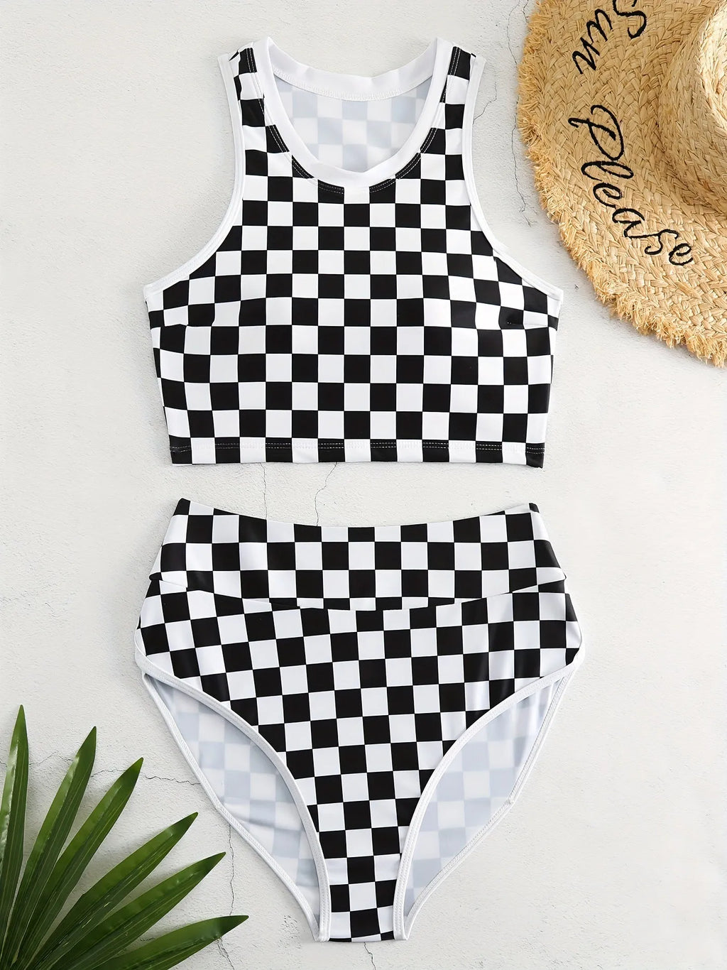 Women's black and white checkerboard plaid backless racing swimsuit with suspender straps.