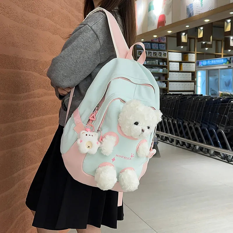 Nylon school backpack in macaron colours with curved shoulder straps and literary style design.