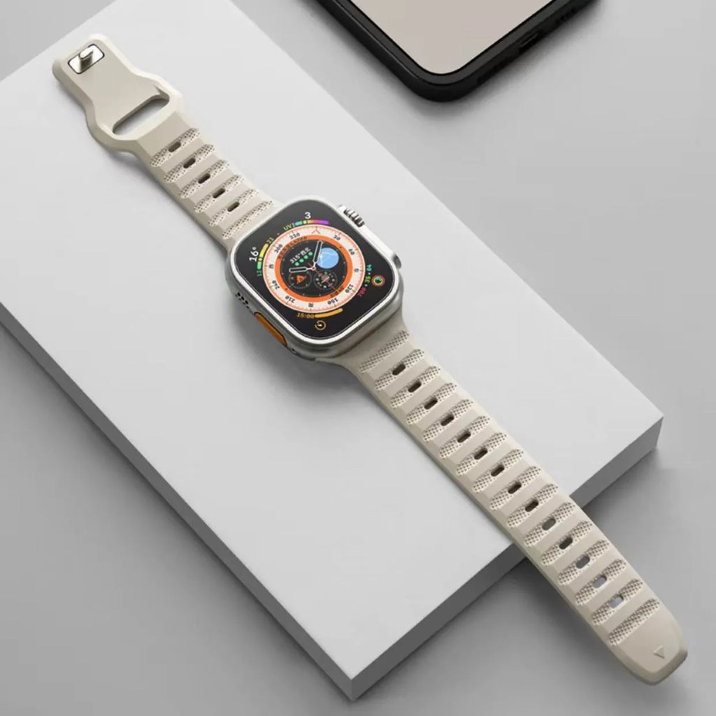Black fluoro rubber Apple Watch band with T-buckle closure on a wrist, showing compatible Ultra model.