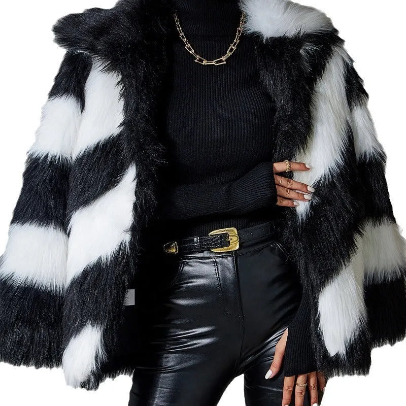 A picture colour faux fur coat with a contrast lapel and a textured fur collar, shown on a hanger.