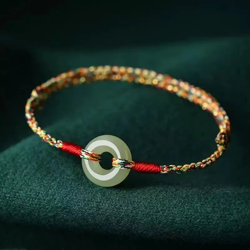 Colourful braided rope bracelet with peace buckle fastening in woven unisex design