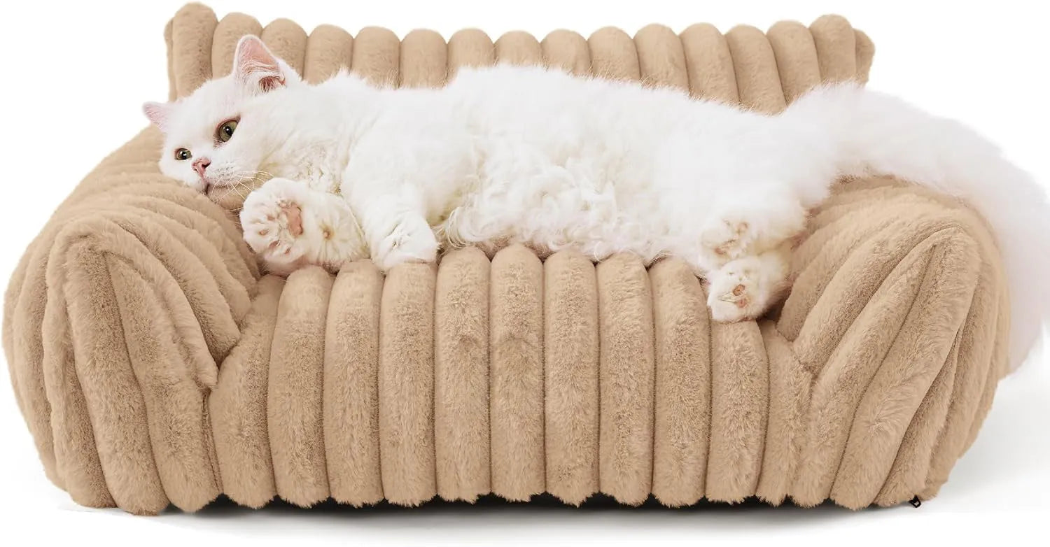Beige corduroy cat couch with high backrest for pet support on a wooden floor.