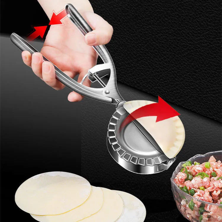 Silver-colour stainless steel manual dumpling mould on a kitchen counter.