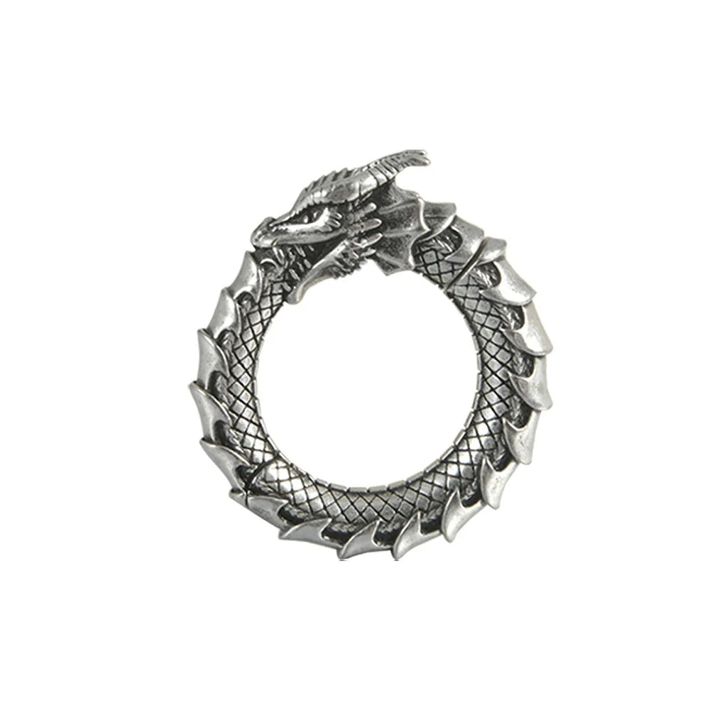 Pair of antique silver dragon-shaped hollow-out earrings with geometric design on a white background