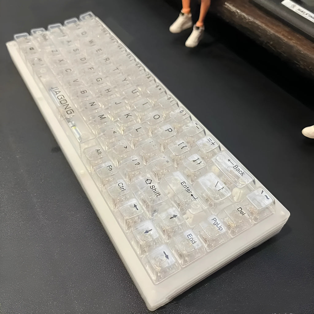 Transparent plastic 132-key mechanical keyboard key cap set displayed on white background
