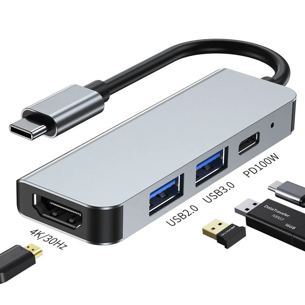 Silver aluminium USB-C expansion dock showing six ports including HDMI, USB 3.0, USB-C PD charging, and card readers
