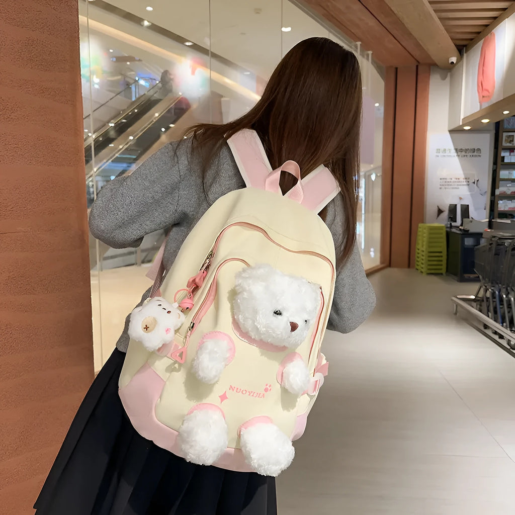 Nylon school backpack in macaron colours with curved shoulder straps and literary style design.