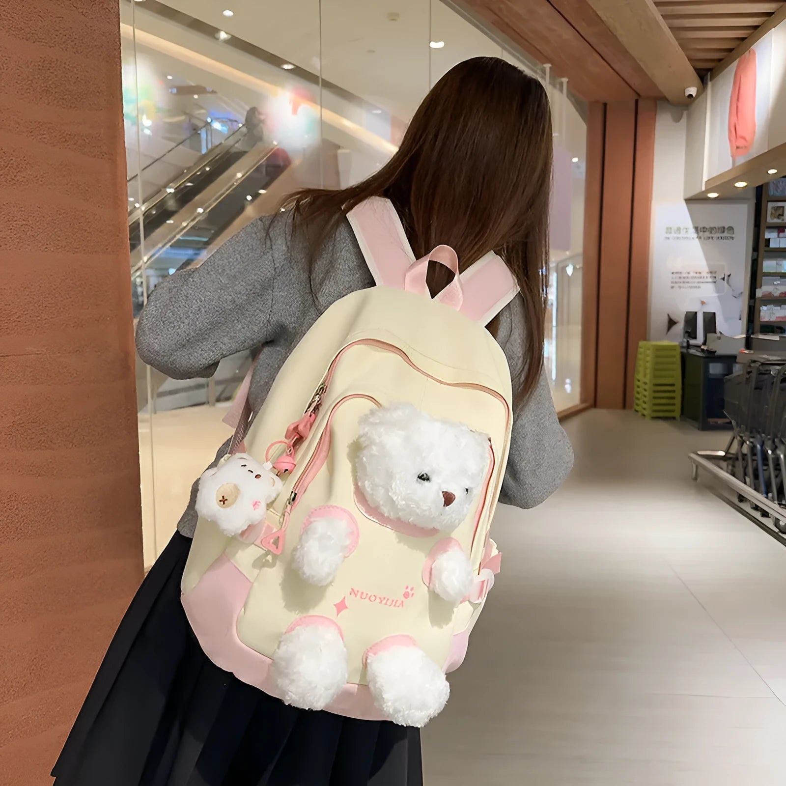Nylon school backpack in macaron colours with curved shoulder straps and literary style design.