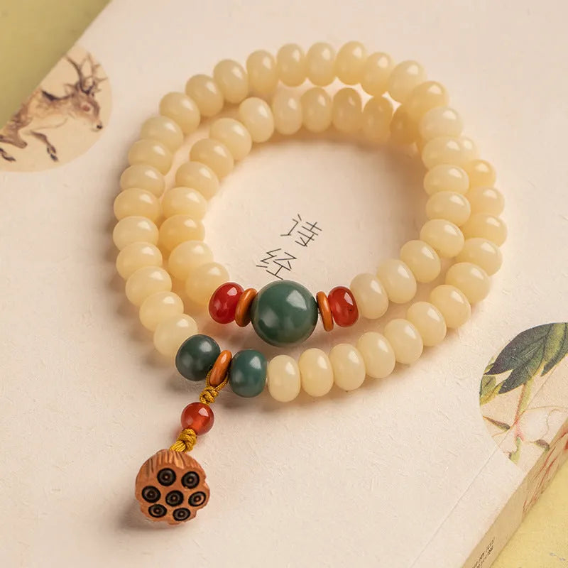 Cream topaz bodhi root wooden bracelet with flat round beads on wrist