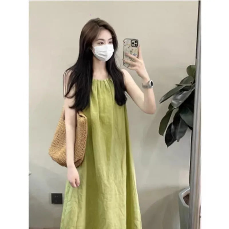 Plus size sleeveless asymmetric cotton blend vest skirt in green with matching black trousers, mid-length street fashion style