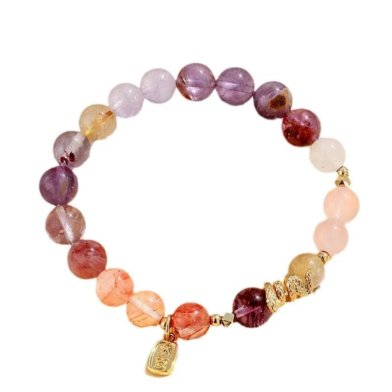 Handcrafted women's crystal bracelet with a lucky snake charm and red sealant flowers on a wrist.