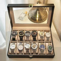 Grey high-grade leather watch storage box with see-through lid showing multiple watch slots.