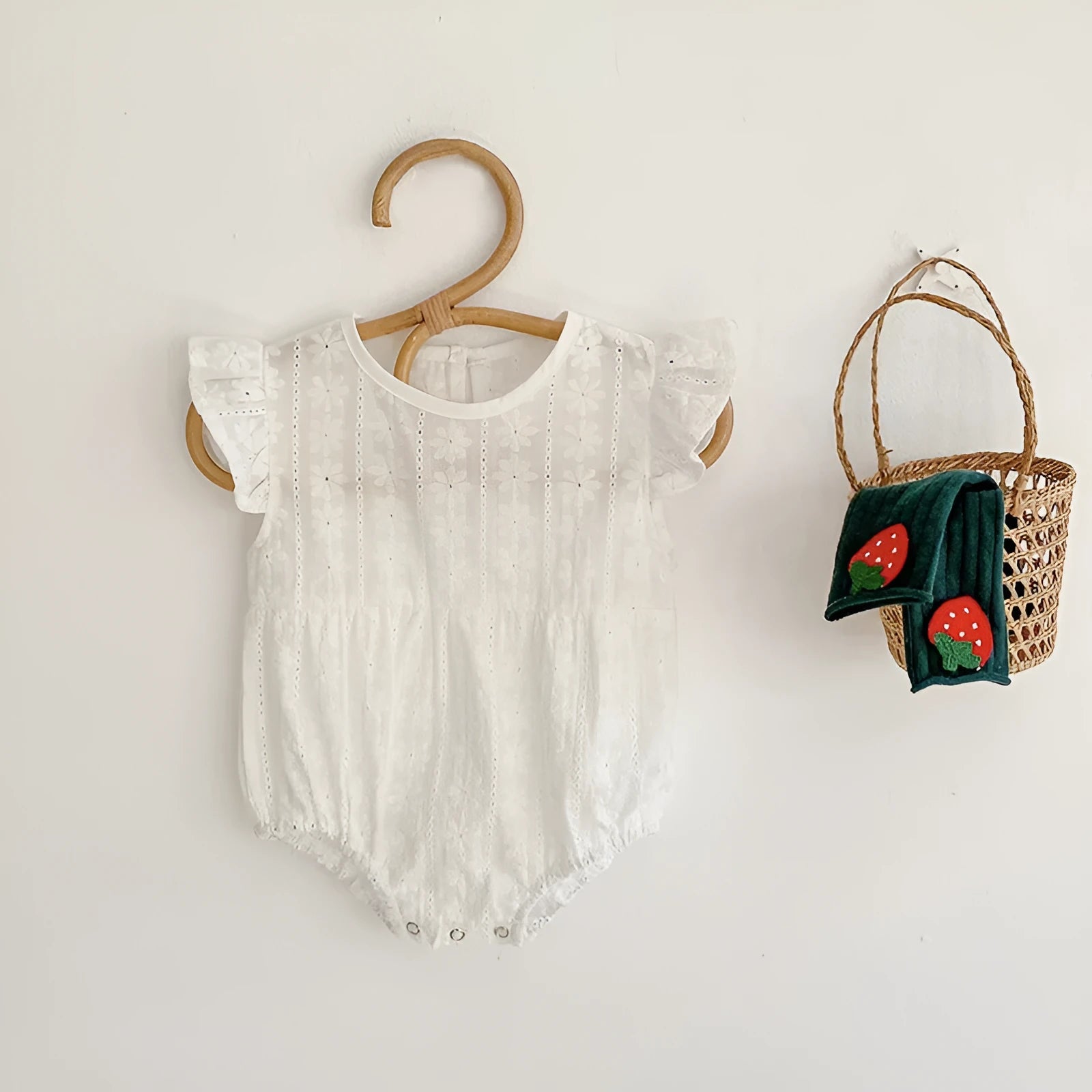 Creamy white cotton lace triangle jumpsuit for baby girl with short sleeves and button closure