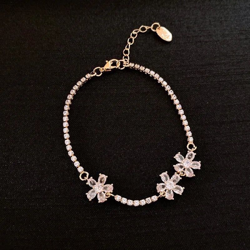 Gold geometric copper bracelet with zircon inlaid detailing and quadrilateral design elements