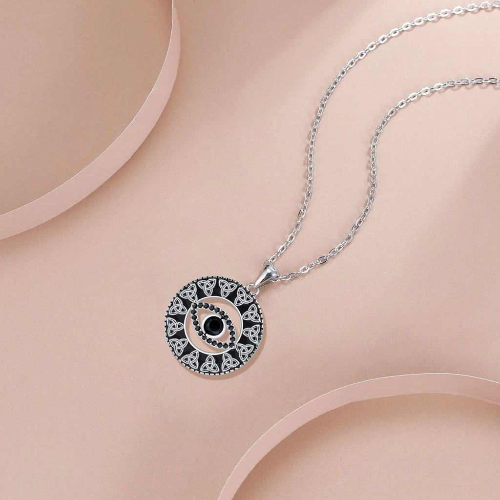 Copper Devil's Eye pendant necklace with a cross chain style on a person or mannequin.