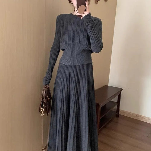 Dark grey knitted sweater and skirt set with a textured 3D pattern and artistic retro ethnic style.
