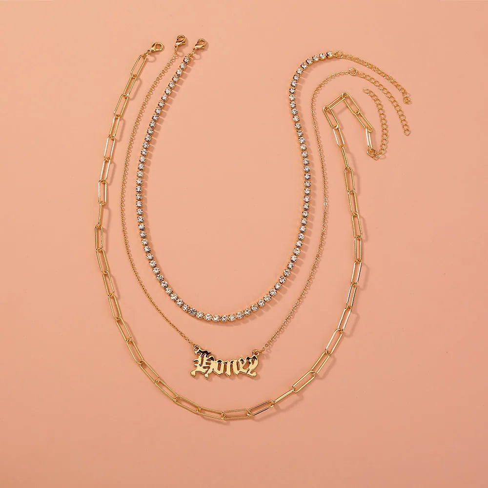Monogram pendant multi-layer necklace on display showing electroplated zinc alloy chain and personalised initial