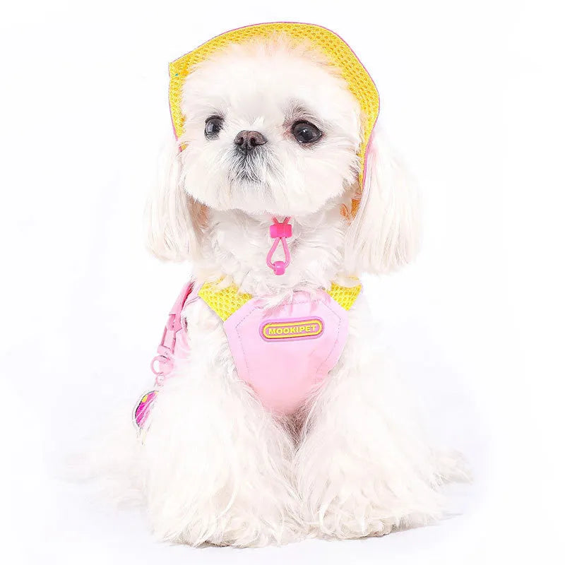 Pink polyester traction vest for small dogs on a Bichon Frisé, showing casual style and lead attachment point.