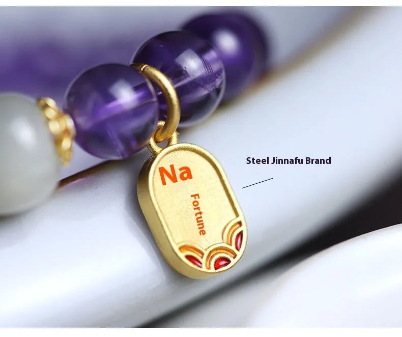 Close-up of a women's amethyst bracelet with 8mm geometric crystal beads on a wrist.