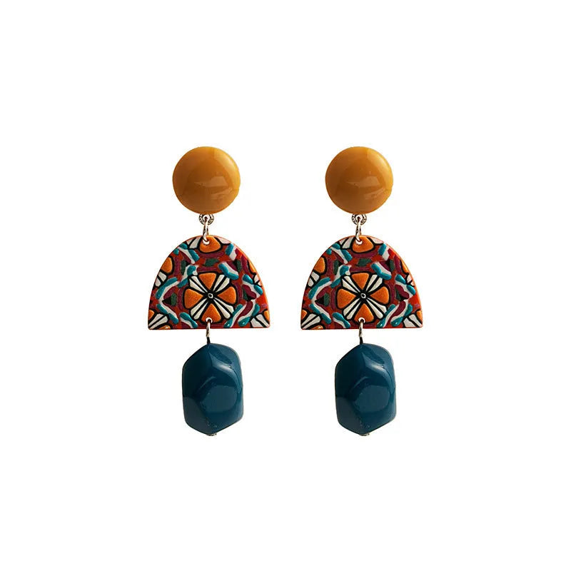 Retro yellow blue contrast acrylic earrings with irregular geometric shapes on white background.