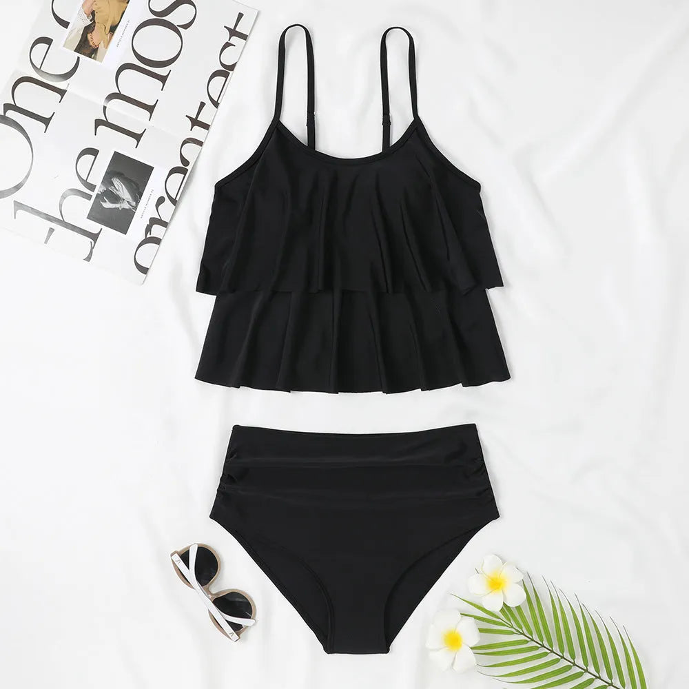 Black high-waisted double-layer swimsuit briefs and sleeveless top laid flat, with a coconut tree print variation.