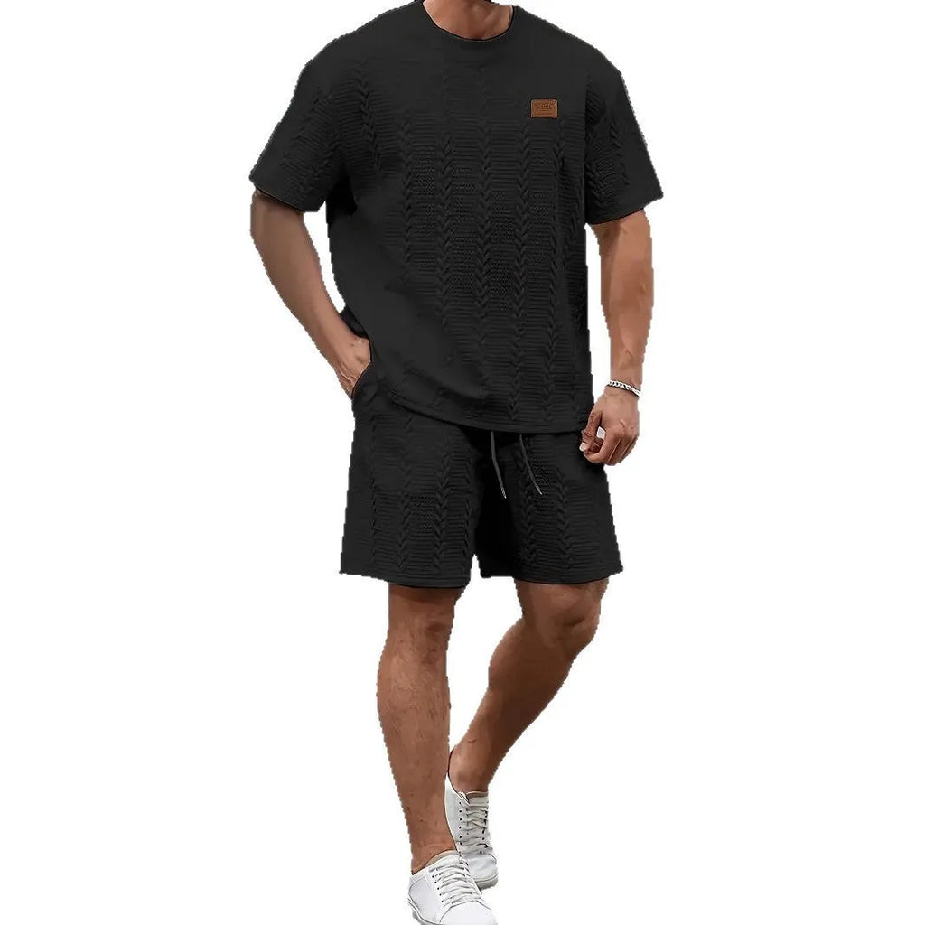 Men's black sportswear set with patch design showing T-shirt and matching shorts