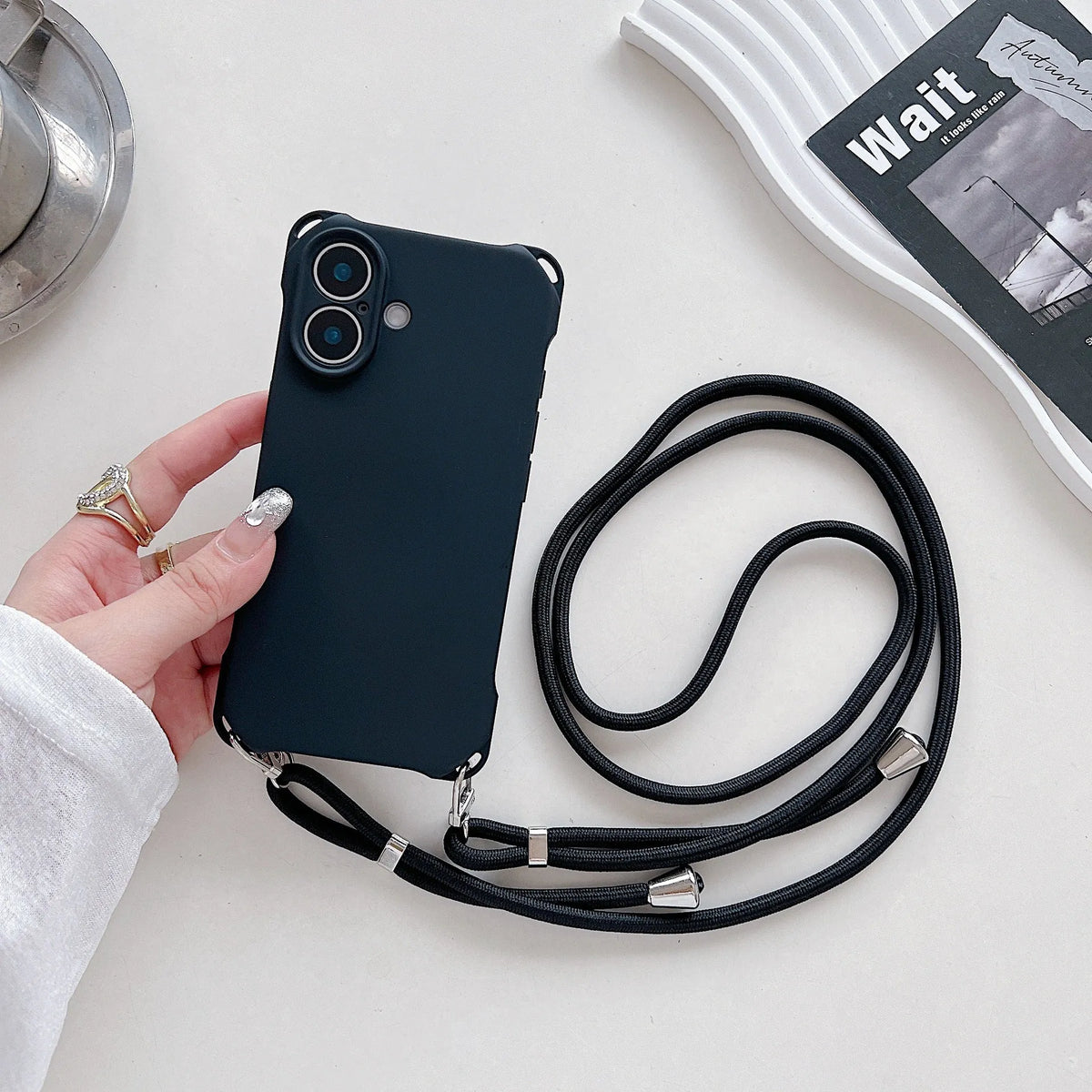 Four-corner cross lanyard liquid silicone phone case for Apple iPhone 16 Pro Max in black with detachable crossbody strap