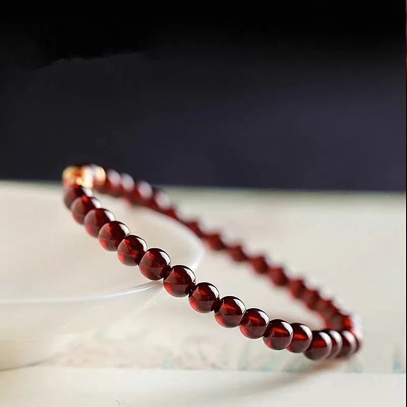 Wine red garnet coloured glass bead bracelet in New Chinese style, shown in single and double circle options.