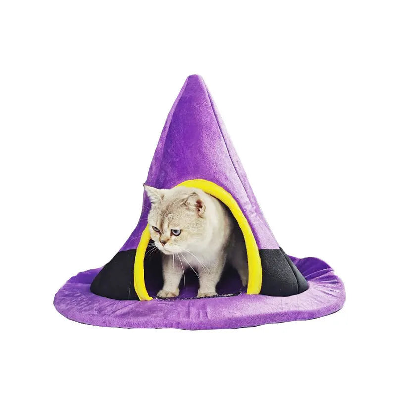 Purple witch hat-shaped cat bed for small pets, shown on a floor.