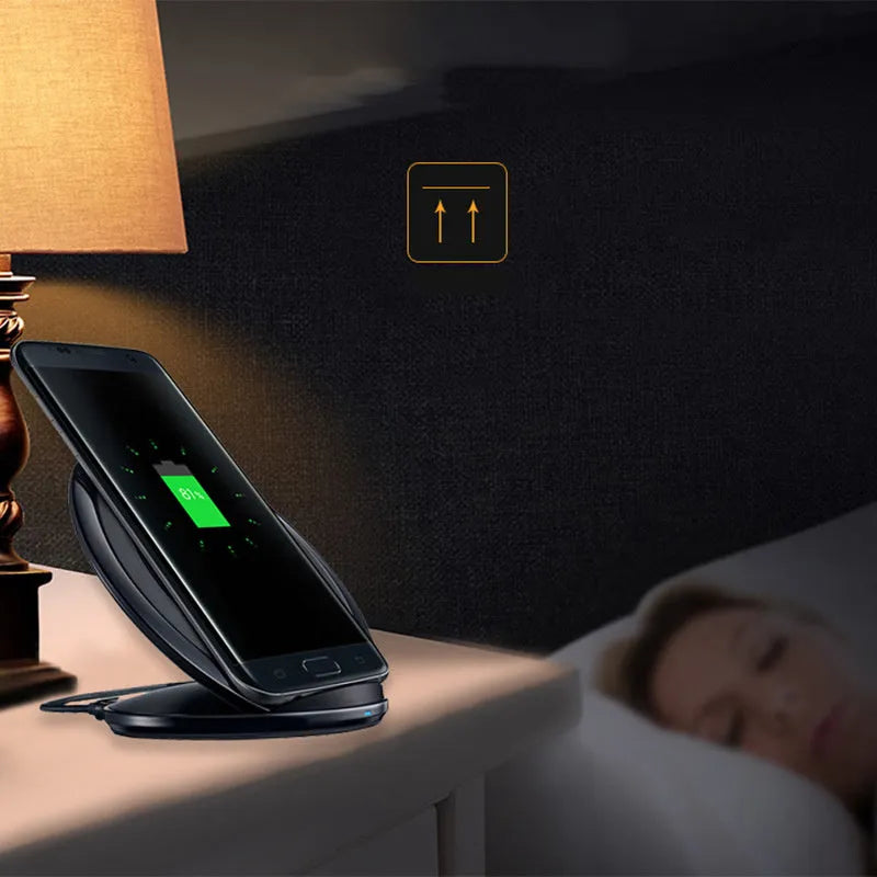 Black and white Qi wireless fast charging pad compatible with Samsung Galaxy Note Edge smartphone.