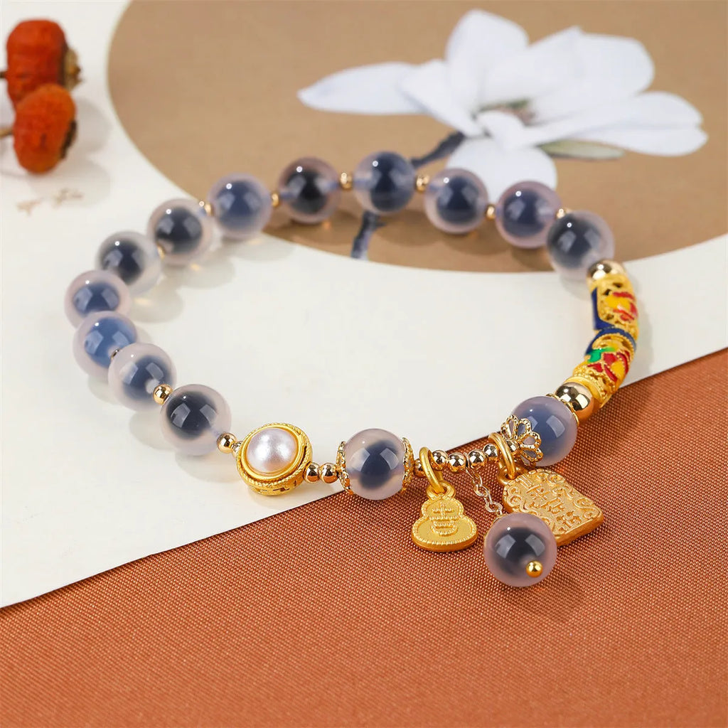 Handmade sugar heart agate bracelet with retro ethnic design on a wrist.