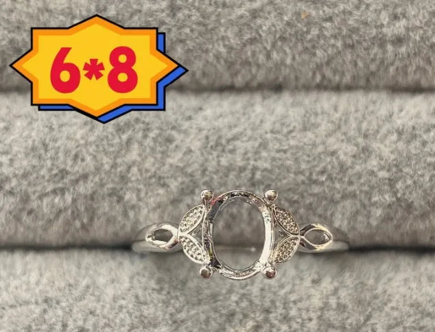 Oval denier open mouth ring with 6x8 main stone and five-pointed star design