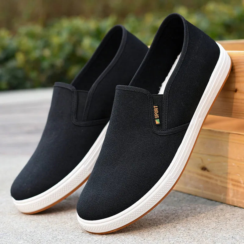 Men's low-top canvas trainers with slip-on design and round toe shape in black colour
